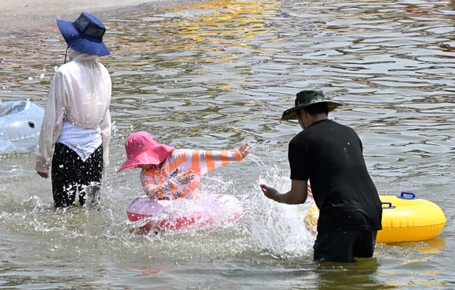 13일 창원시 마산합포구 광암해수욕장을 찾은 한 가족이 물놀이를 하며 더위를 식히고 있다./성승건 기자/